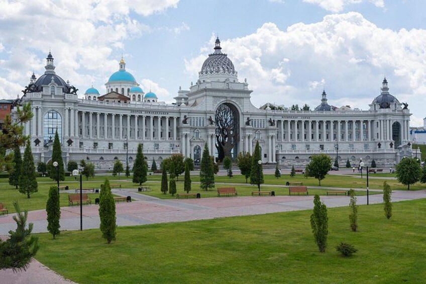 A large white building with blue domes and a central clock tower. 3