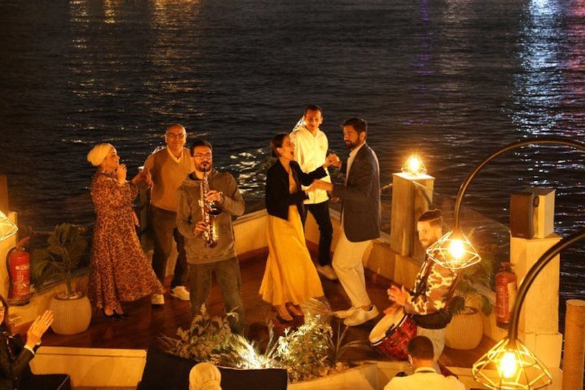 A group of people on a boat with a body of water in the background. 2