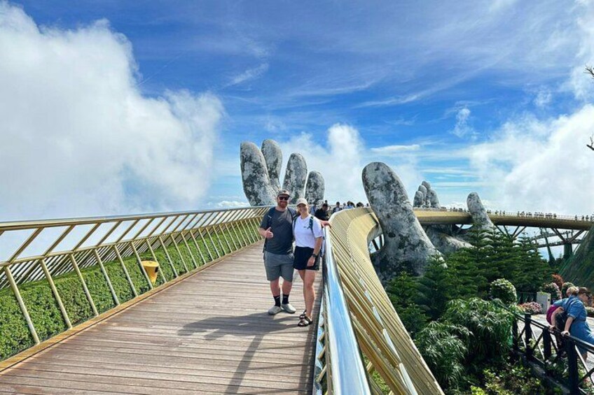 A wooden boardwalk with large rock formations and a clear sky. 1
