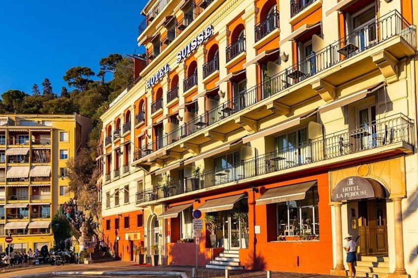 A multi-story hotel with balconies and a sign that reads 'HOTEL LA PAPIROUSE.' 2