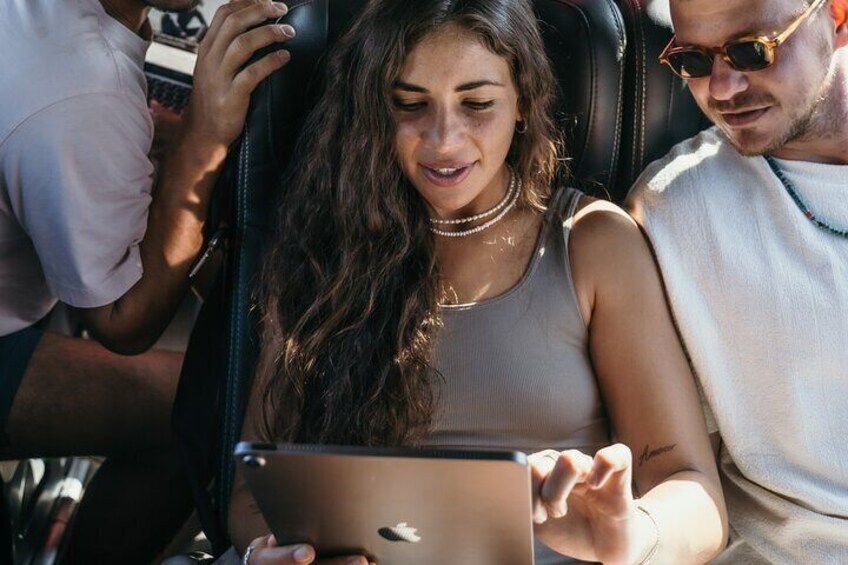 A person using a laptop in a vehicle. 1