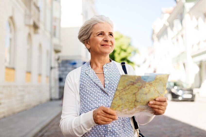 A person holding a map on a city street. 1