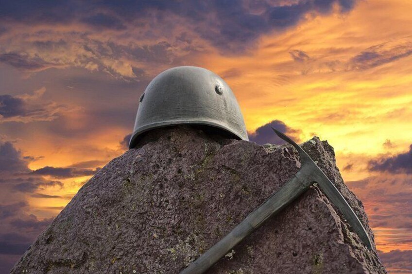 A helmet on a rock with a sunset in the background. 4