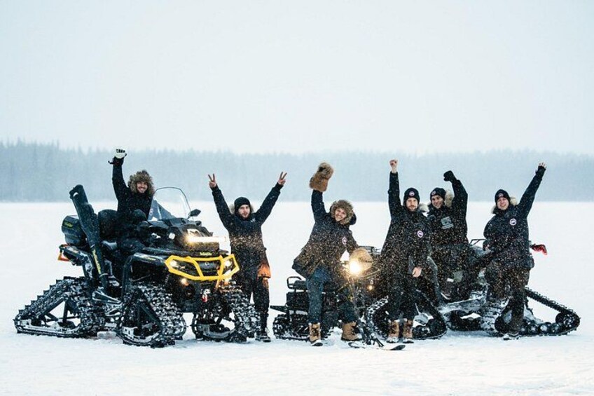A group of people on snowmobiles in a snowy landscape. 2