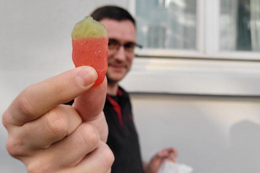 A person holding a red and yellow object. 2