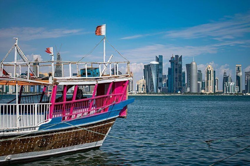 A colorful boat with a city skyline in the background. 2