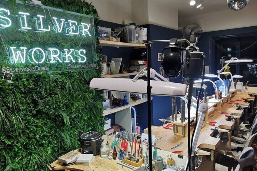 A dental clinic interior with a neon sign reading "SILVER WORKS" and various dental equipment. 5