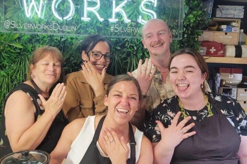 A group of people posing in front of a backdrop with the text "WORKS" and the hashtags "#SILVERWORKS DUBLIN" visible. 4