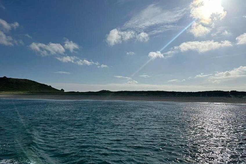 A calm sea with a clear sky and distant land. 4