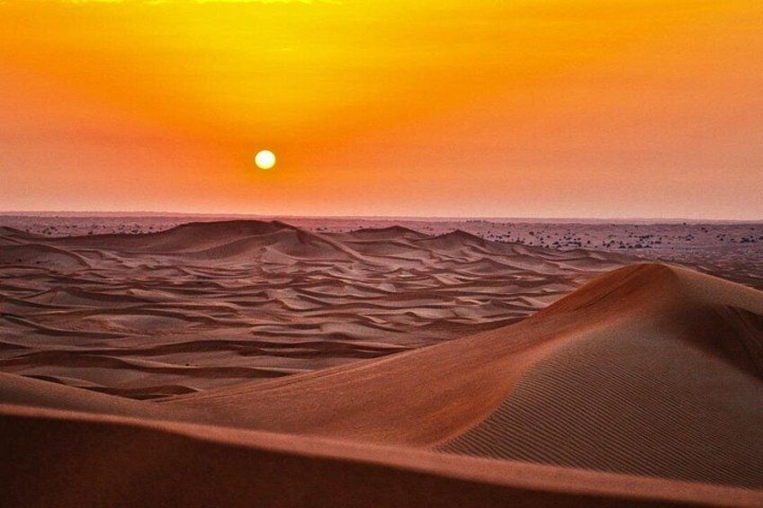 A desert landscape with sand dunes and a sunset. 2