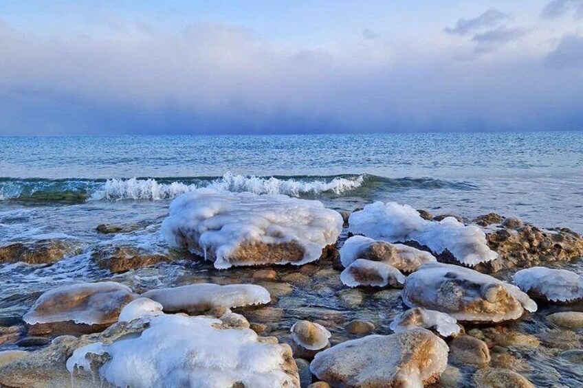 A rocky shoreline with ice formations. 3