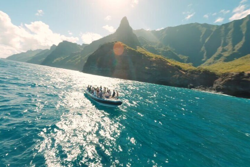 A boat on a turquoise sea with mountains in the background. 2
