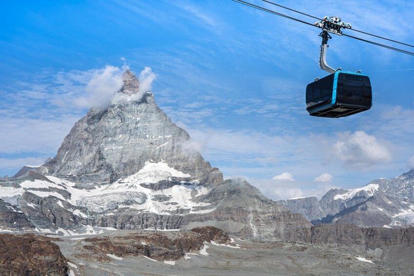 A mountain peak with a ski lift cable car. 1