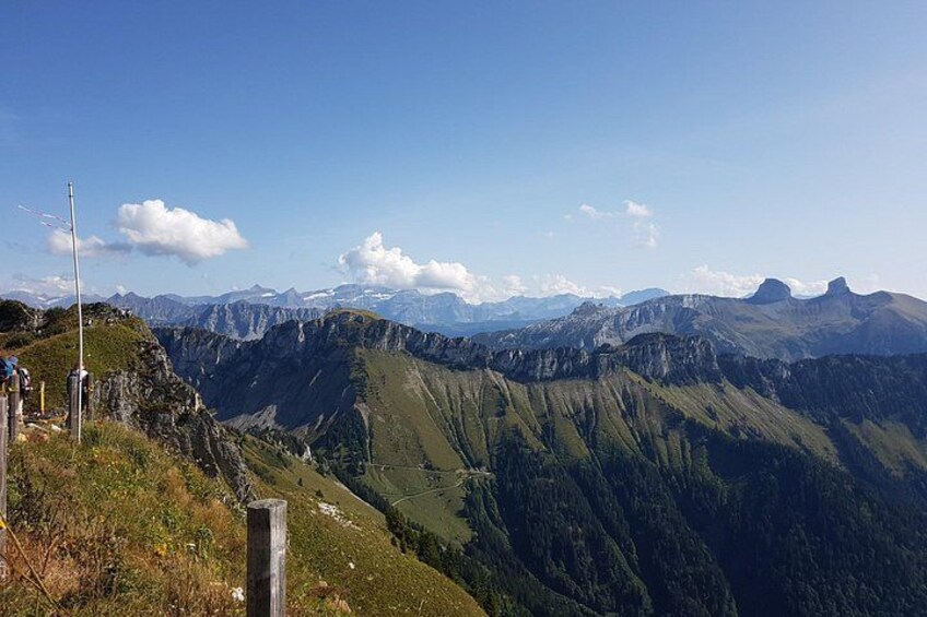 A mountainous landscape with a clear sky, a wooden post, and a metal pole. 5