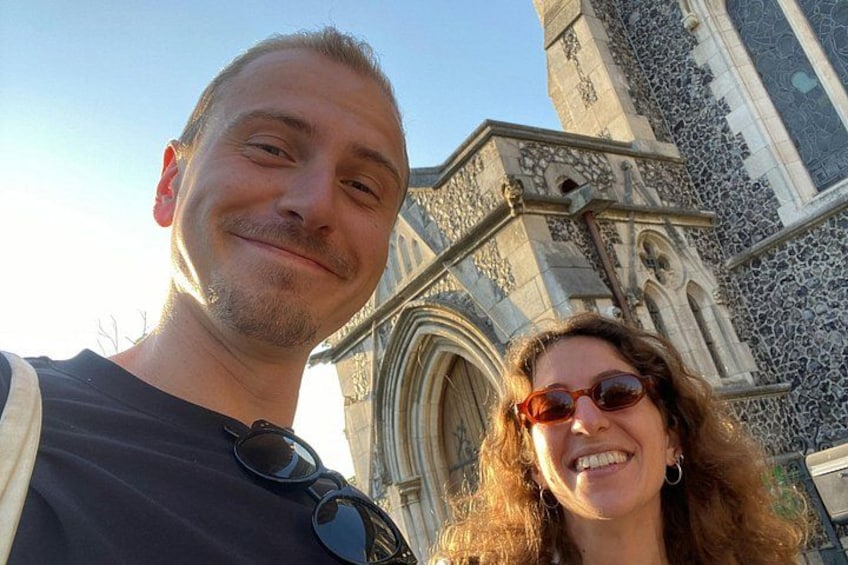 A person taking a selfie with a historic building in the background. 1