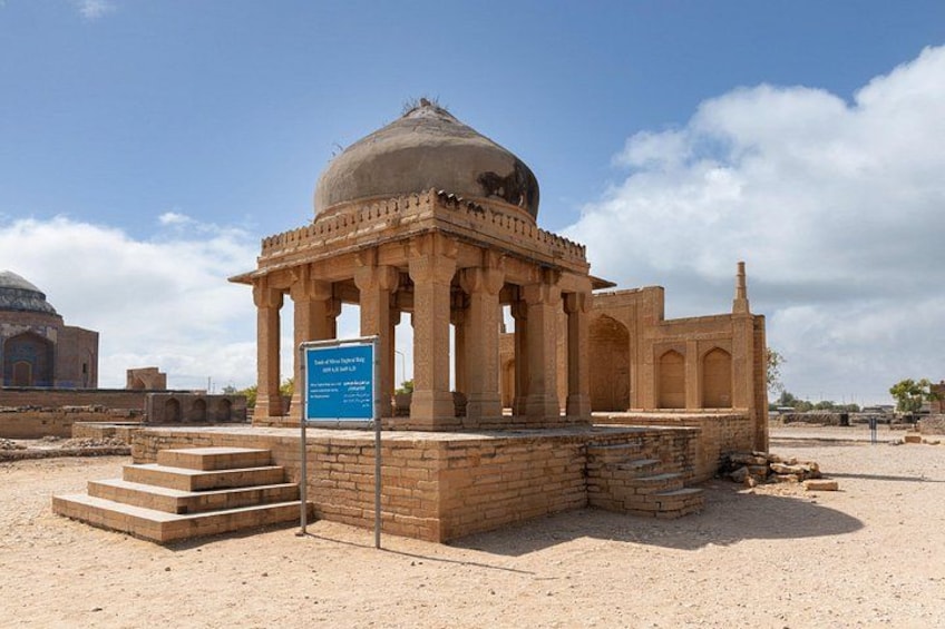 A historical building with a dome and columns, surrounded by a desert landscape. 3