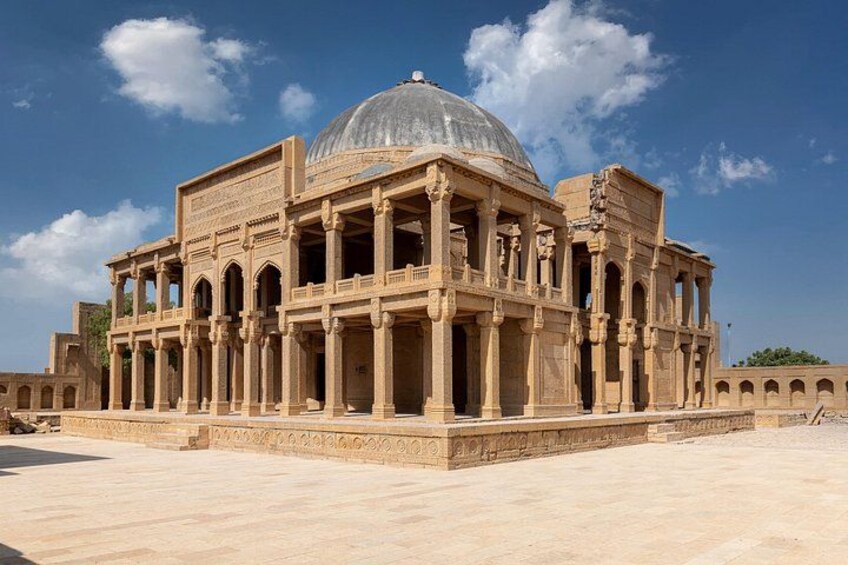 A large, historic building with a dome and multiple arches. 1
