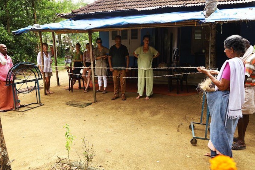 A group of people gathered under a blue-roofed structure in a rural setting. 5