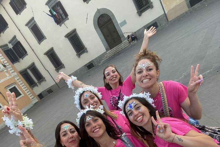 A group of people in a public square with a building in the background. 4