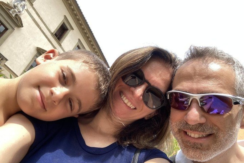 Three people taking a selfie in front of a building with classical architecture. 5