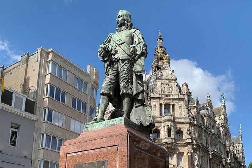 A statue of a historical figure in front of a grand building with intricate architecture. 5