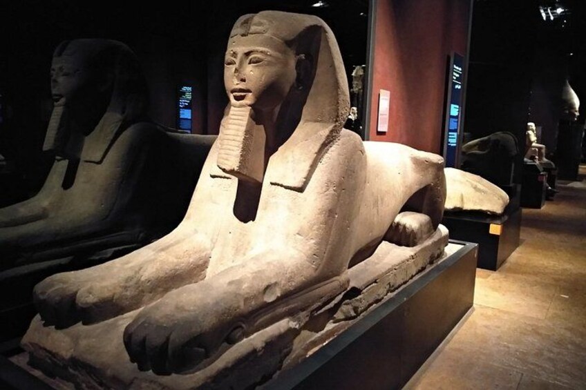 A sarcophagus with hieroglyphs and a cobra head. 1
