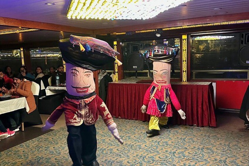 Two performers in elaborate costumes in a restaurant. 2
