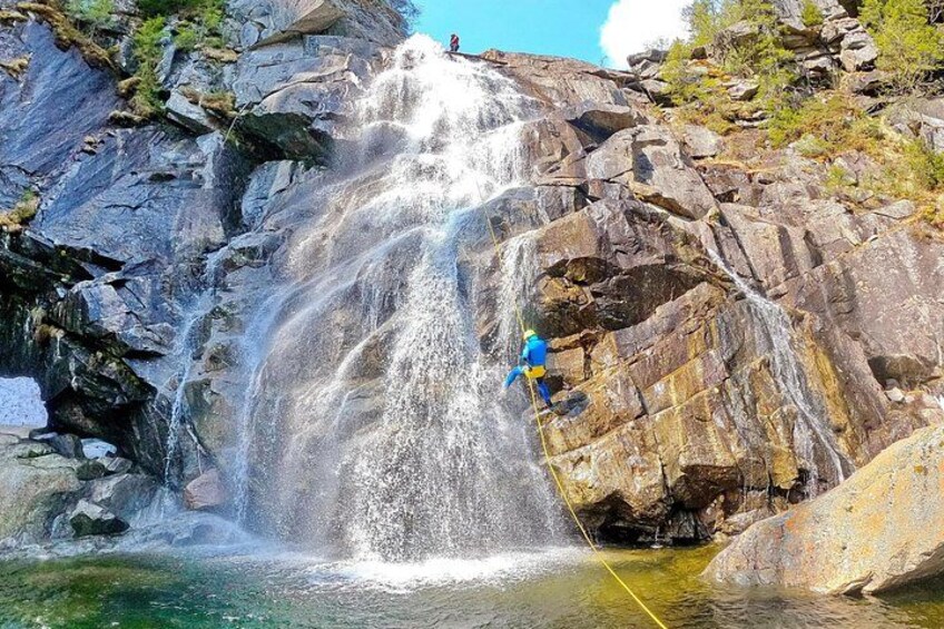 A person rappelling down a waterfall. 1