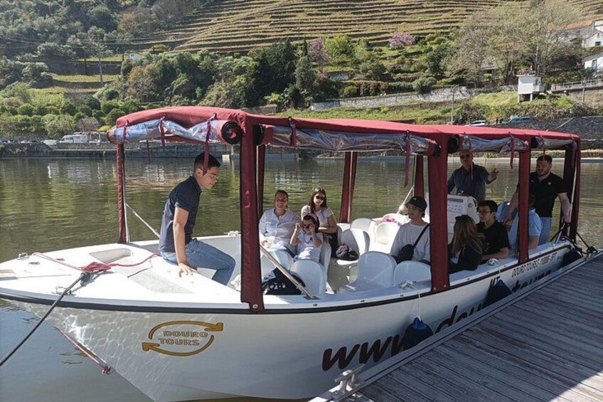 Ein Boot mit Personen an einem Steg, umgeben von Wasser und viel Grün. 3
