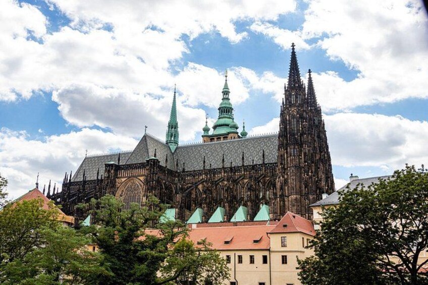 A historic cathedral with intricate architecture, a prominent spire, and a green-tiled roof. 2