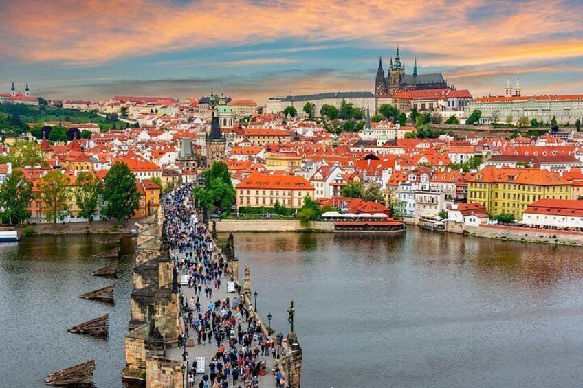 A river with a bridge, historic buildings, and a prominent church tower. 3