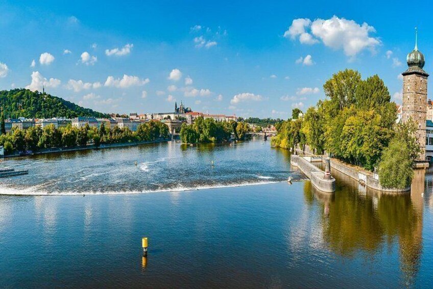 A river with a bridge, a tower, and a cityscape in the background. 5