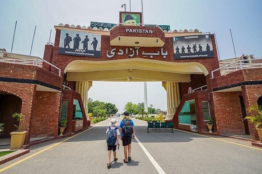 A large archway with 'Pakistan' written on it, leading to a road. 5