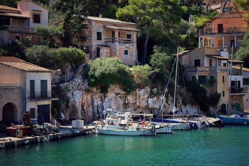 A coastal town with buildings, a dock, and boats. 2