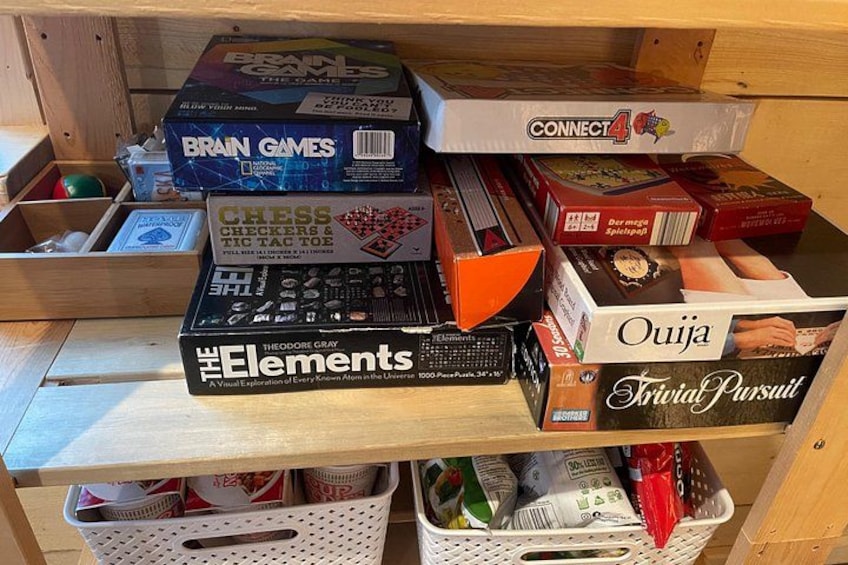 A shelf with various board games including Brain Games, Connect4, and Chess. 2