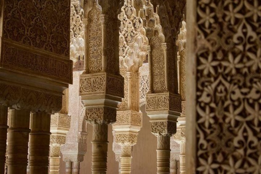 Intricately carved columns and arches, typical of Islamic architecture. 4