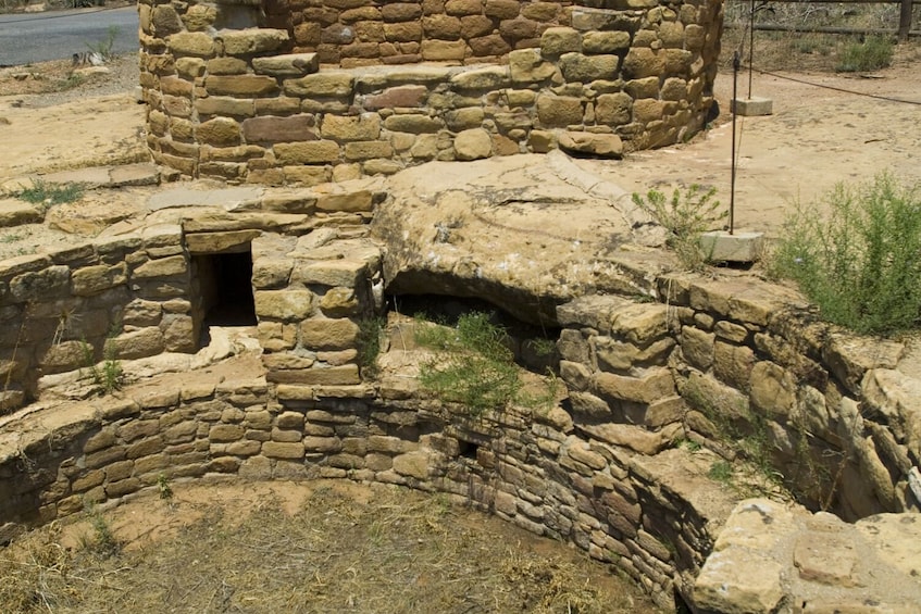 Ancient stone ruins with a circular structure and a small opening. 5