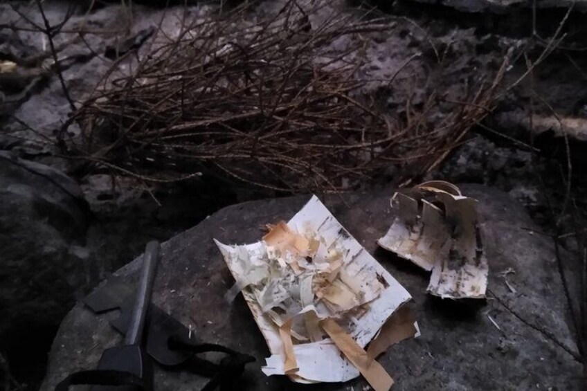 A piece of paper with shredded paper and a metal object on a rough surface. 4