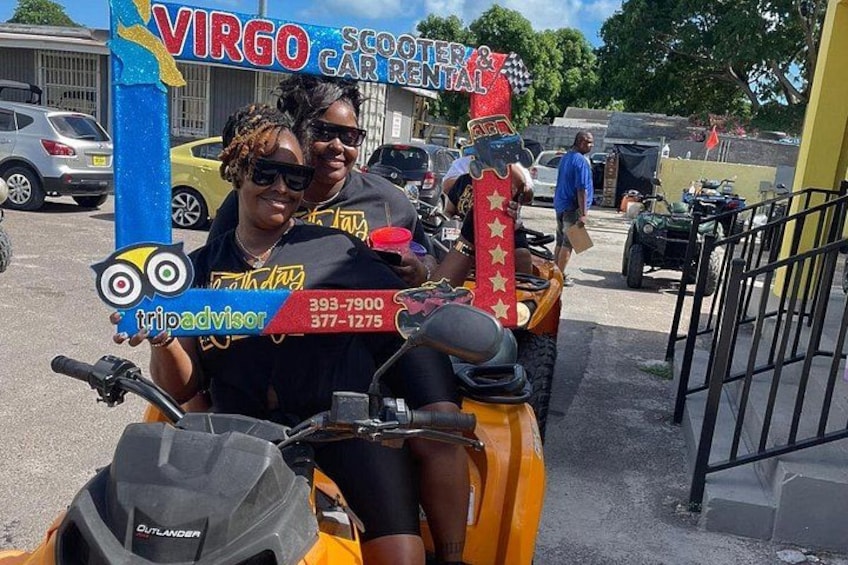 A scooter rental service with a colorful sign, a contact number, and a branded helmet. 2