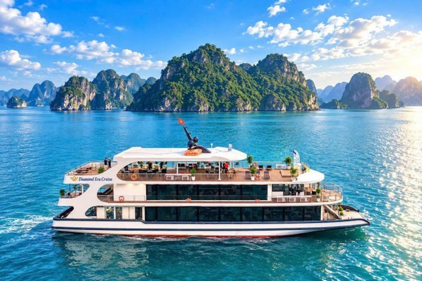 A large cruise ship named Diamond Era Cruise sailing in a turquoise sea with mountainous islands in the background. 5