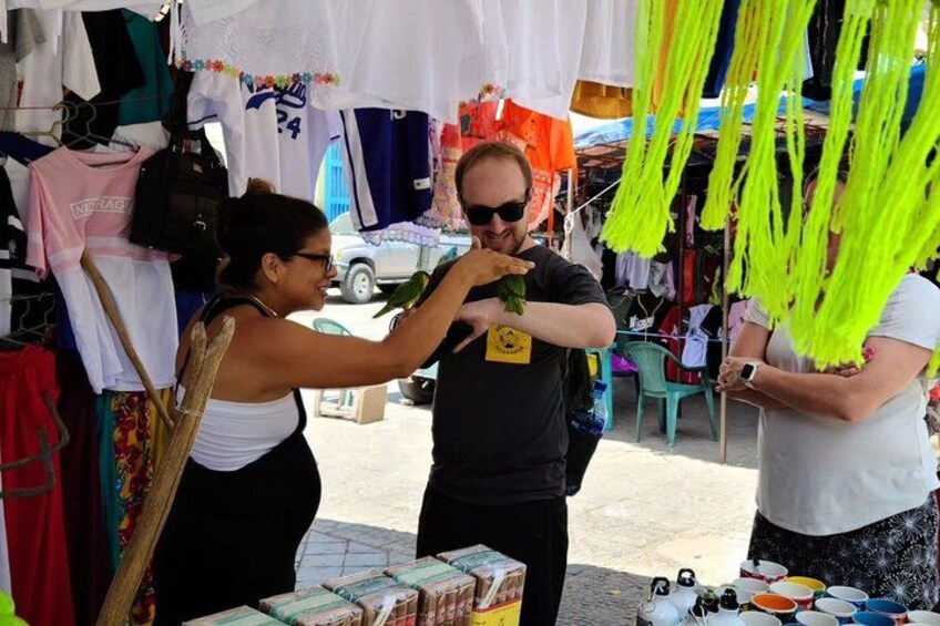 A market stall with various items for sale, including clothing and accessories. 2