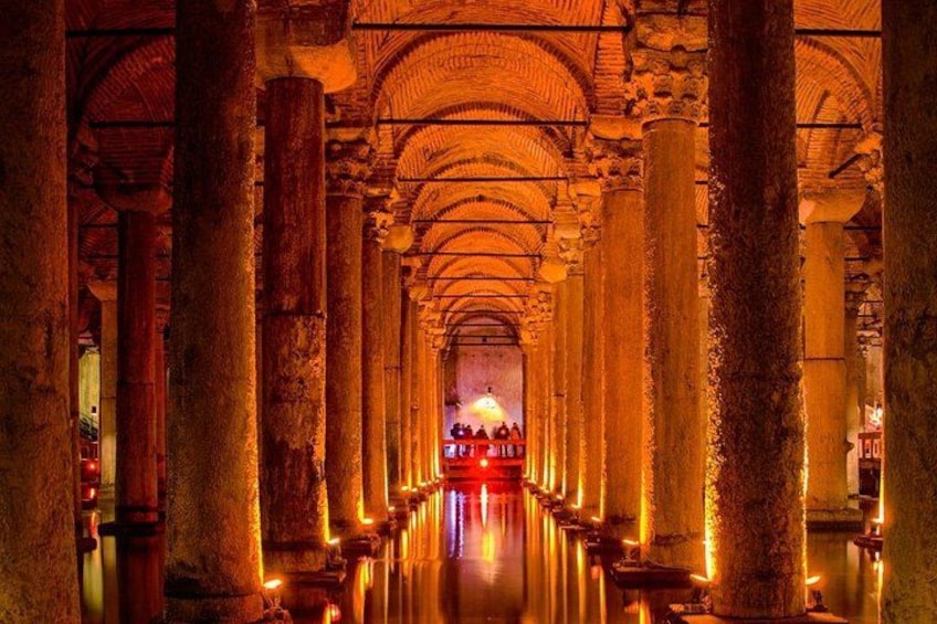 A grand, illuminated interior with high, arched ceilings and columns. 2
