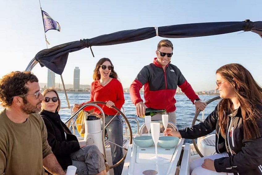 A group of people on a sailboat with a city skyline in the background. 2
