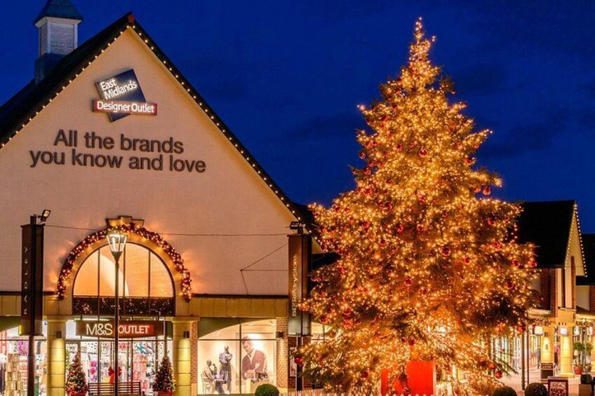 A building with a Christmas tree and a sign that says 'All the brands you know and love.' 3