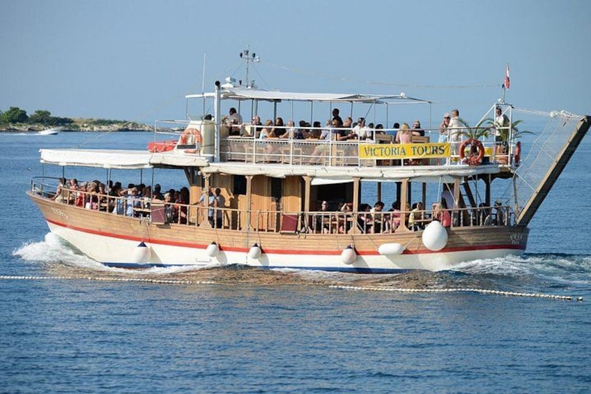 A boat with a sign reading 'Victoria Tours' on the water. 2