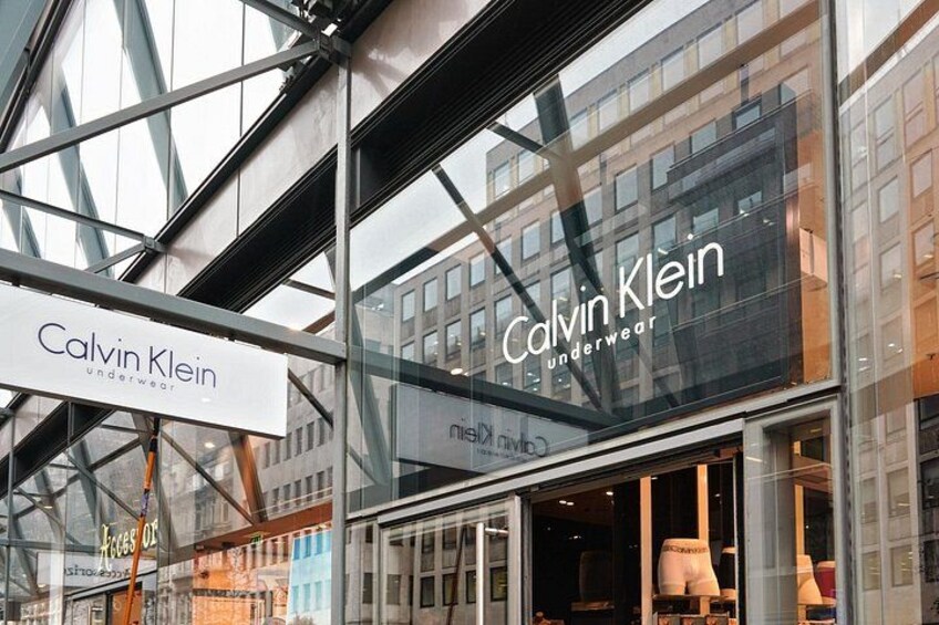 A modern building with a glass facade and signage for Calvin Klein underwear. 2