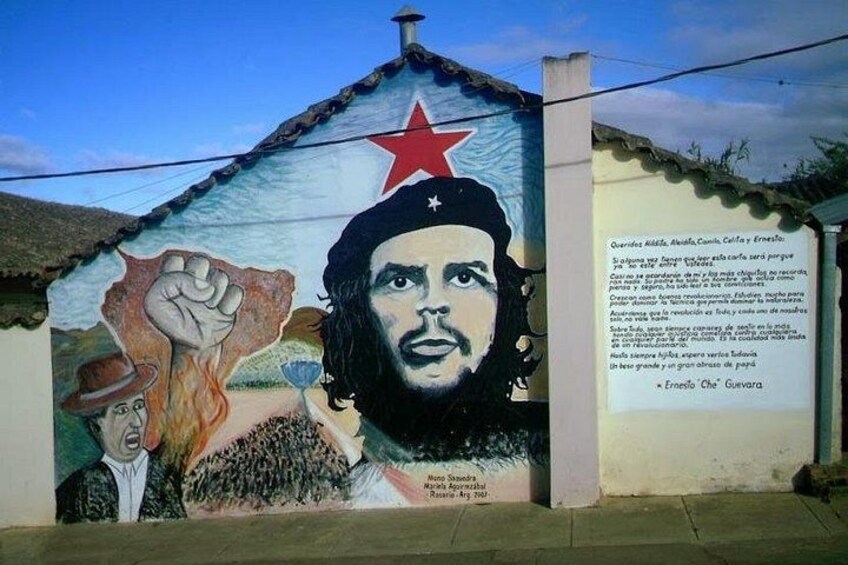A mural with a raised fist, a star, and a portrait of a man. 5