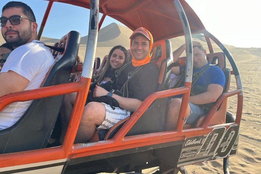 A group of people in a desert safari vehicle. 4