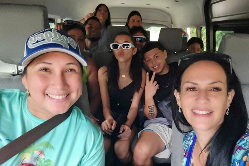 A group of people inside a vehicle with a seatbelt. 5