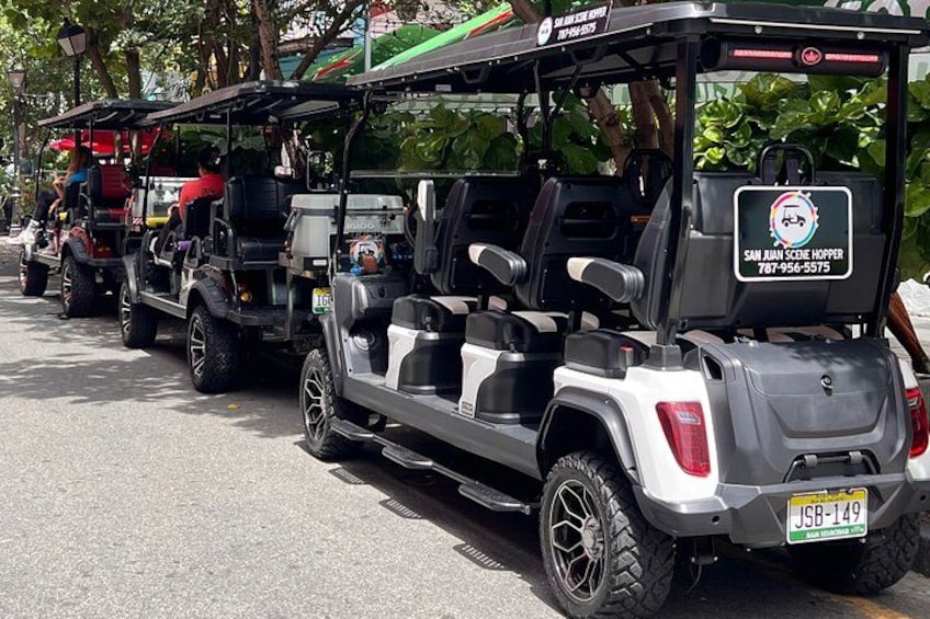 A line of golf carts on a street. 3